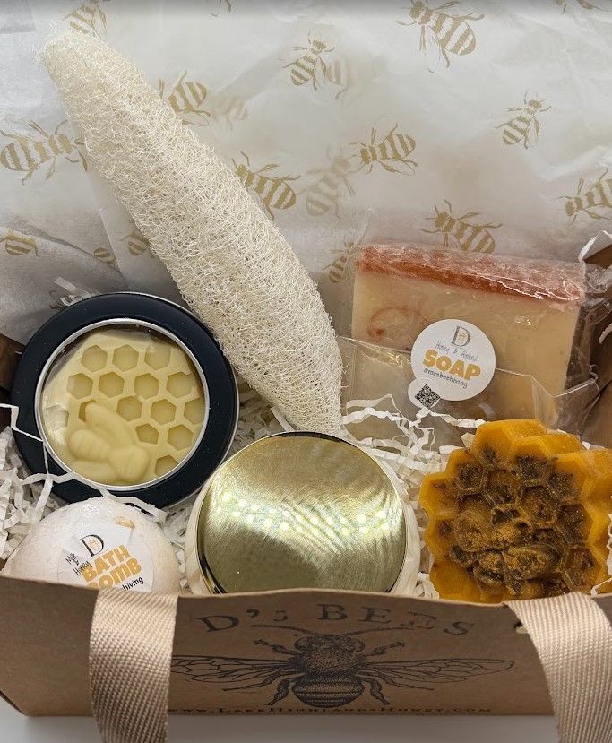 Luxury build-your-own gift set with beeswax body products, loofah, soap, and gold bee tissue paper in a kraft gift bag