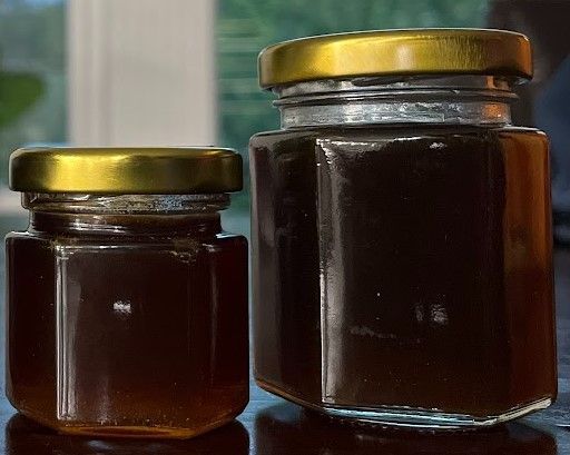 Classic mason jar filled with golden Lake Highlands Honey.