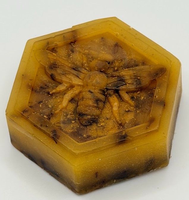 Beeswax Body Care Gift Set with honey bath bomb, lotion bar, and handmade soap in a kraft gift basket