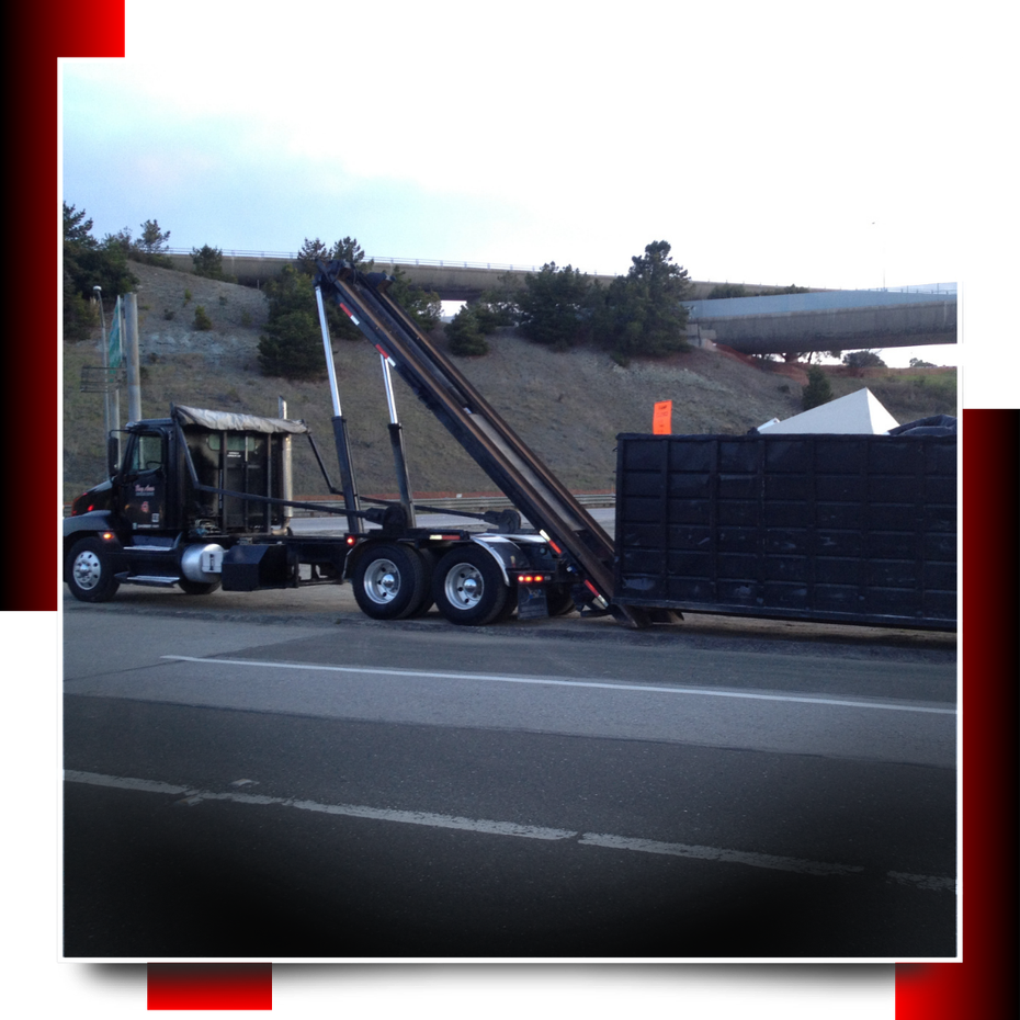Dumpster truck parked on the road