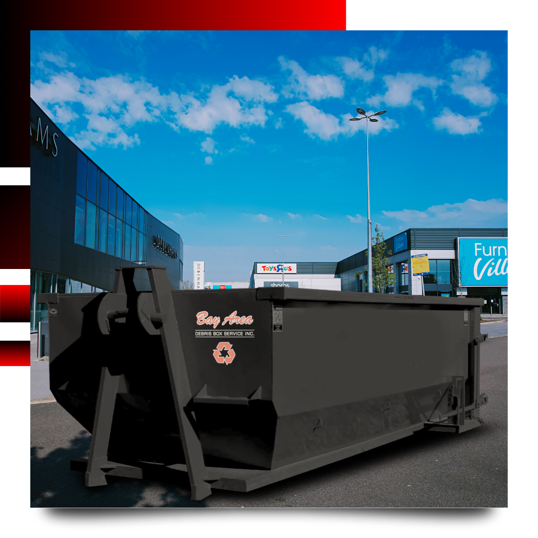 Dumpster in front of a house with graphics behind it.