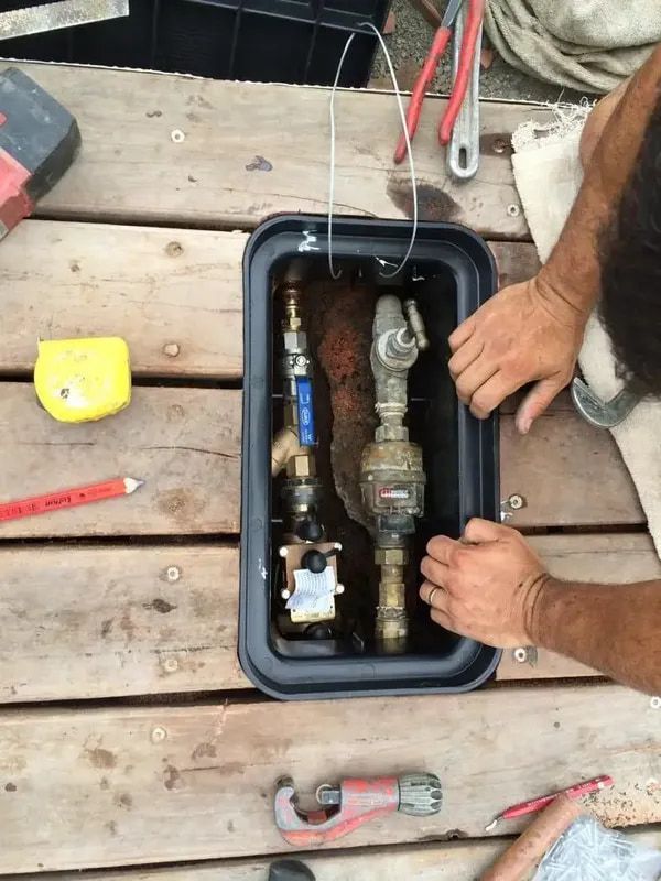 Professionals Fixing Pipes — Hot Water Service in Forster Area