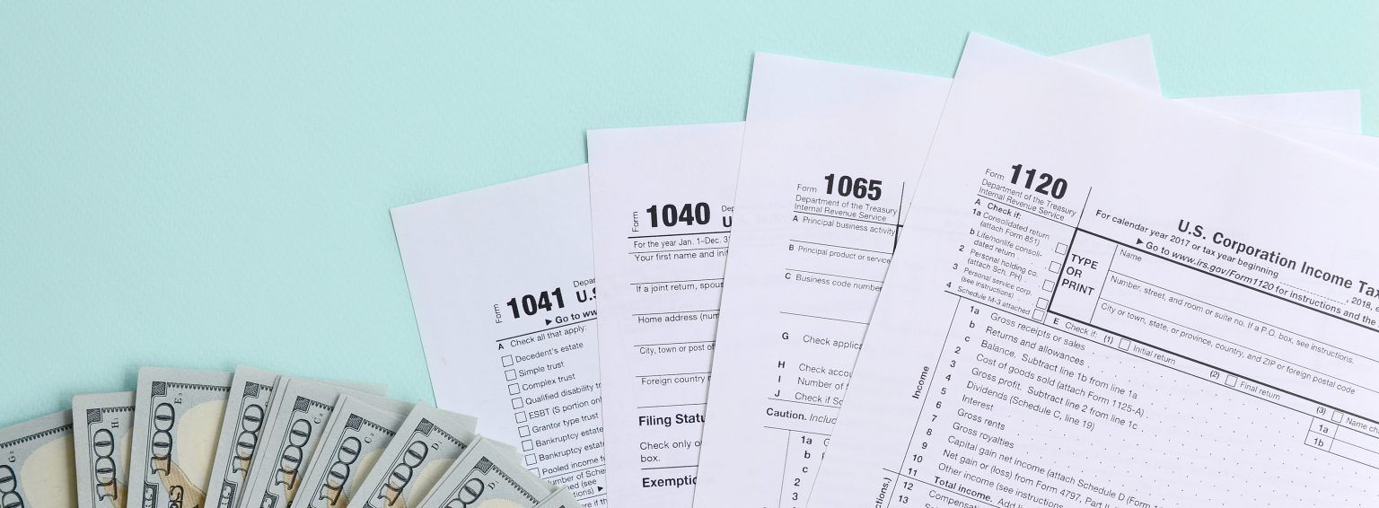 One Hundred Dollar Bills and Tax Forms — Jacksonville Beach, FL — Tax Advantage