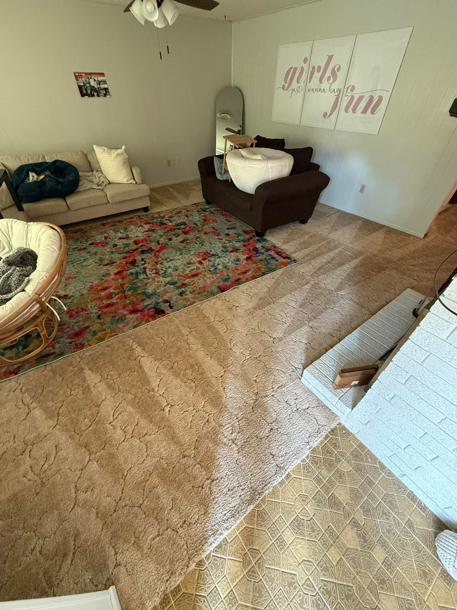 A living room with a couch , chair , and rug.