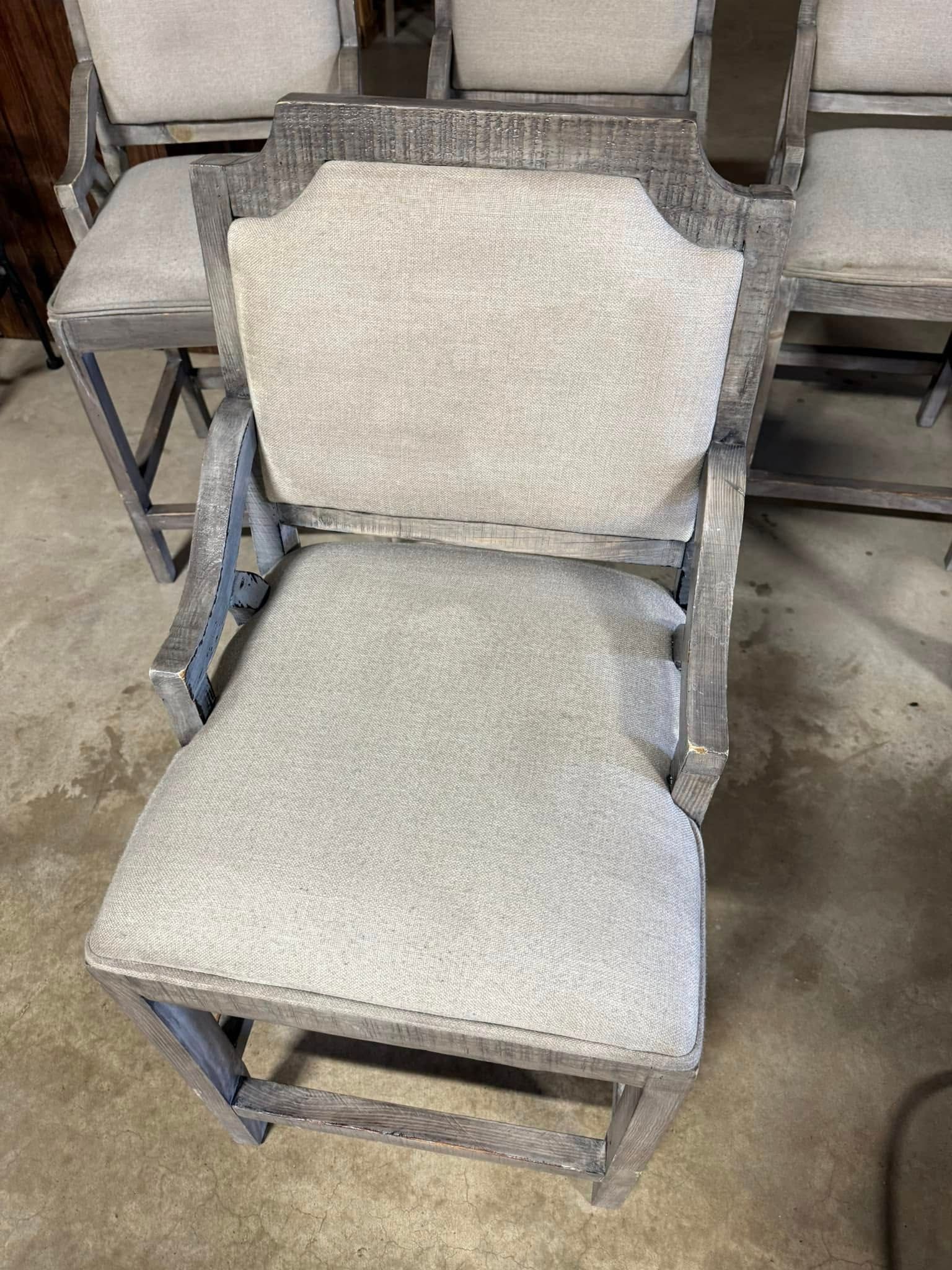 A chair and ottoman are sitting on a concrete floor.