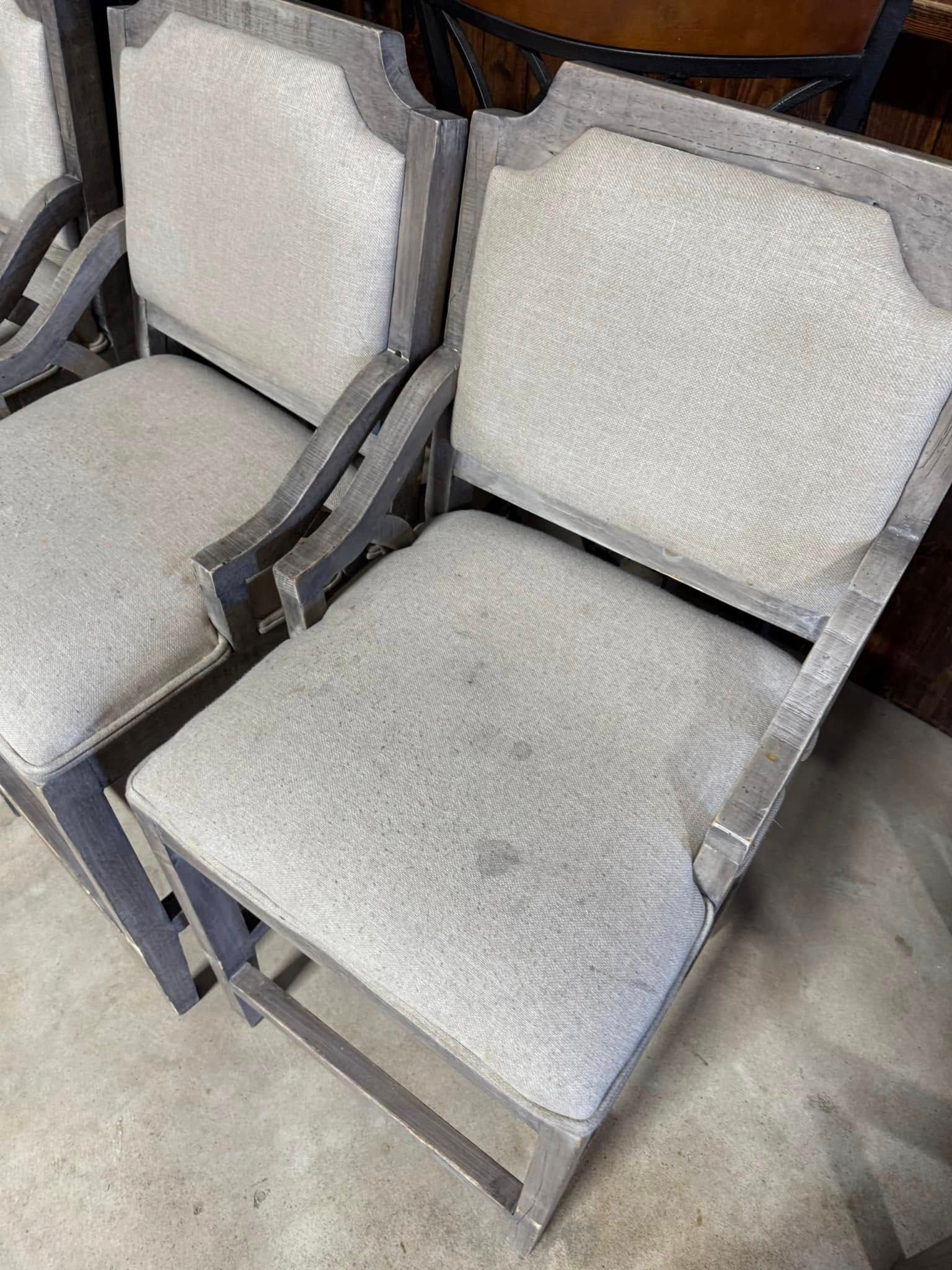 A couple of chairs sitting next to each other on a concrete floor.