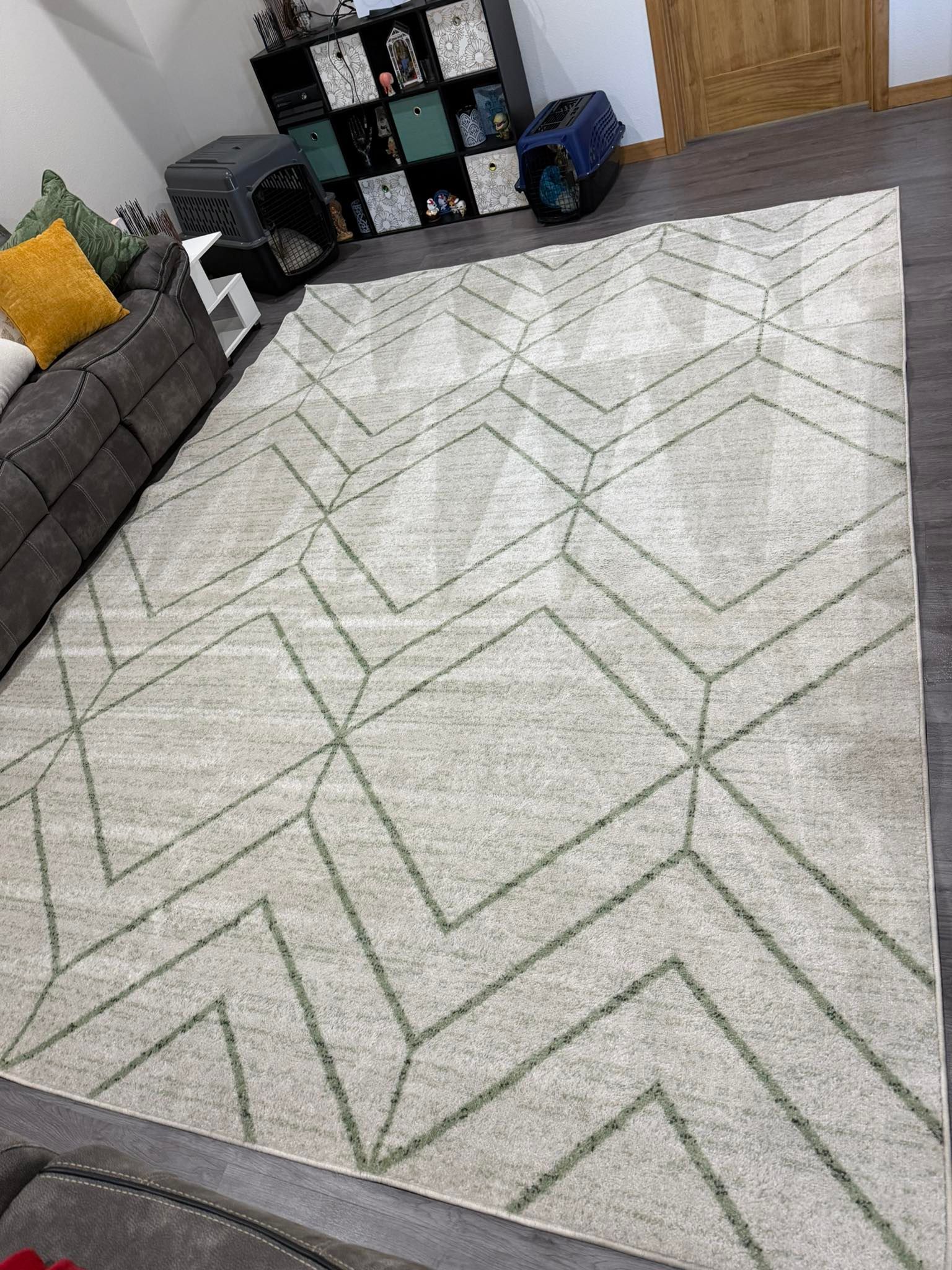A living room with a rug on the floor and a couch.