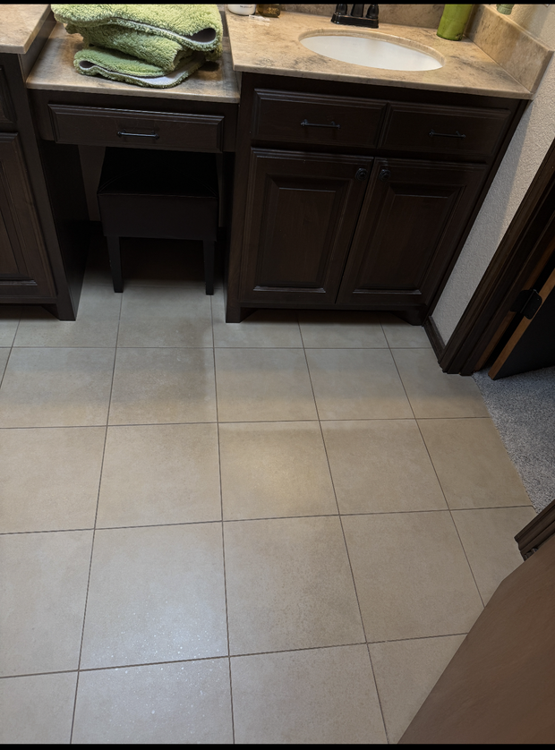 A bathroom with two sinks and a tiled floor