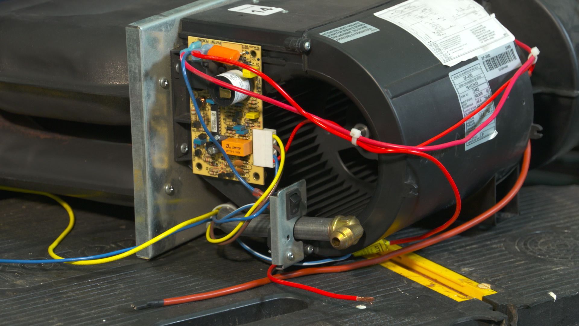 A close up of a motor with wires attached to it