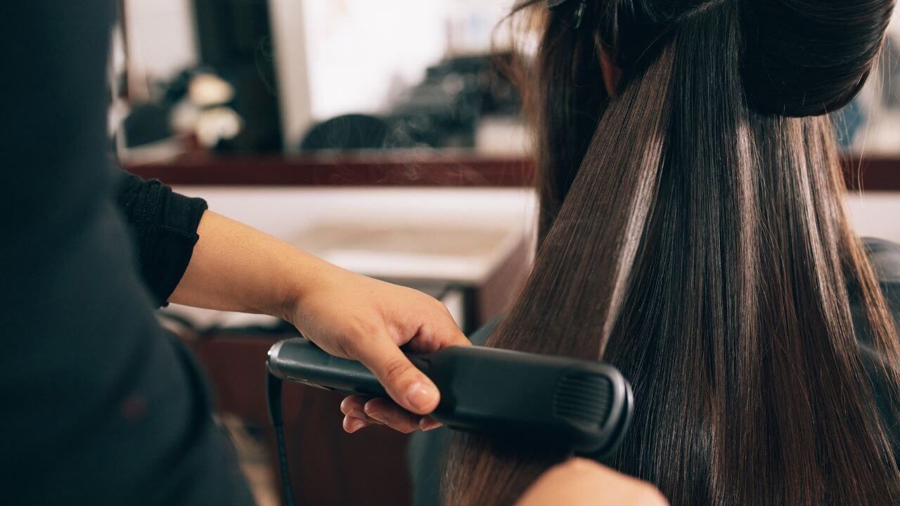 Lady drying her hair with blow dryer.