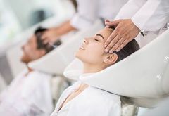A client enjoying a revitalizing hair treatment at Redhead Studio's mobile salon