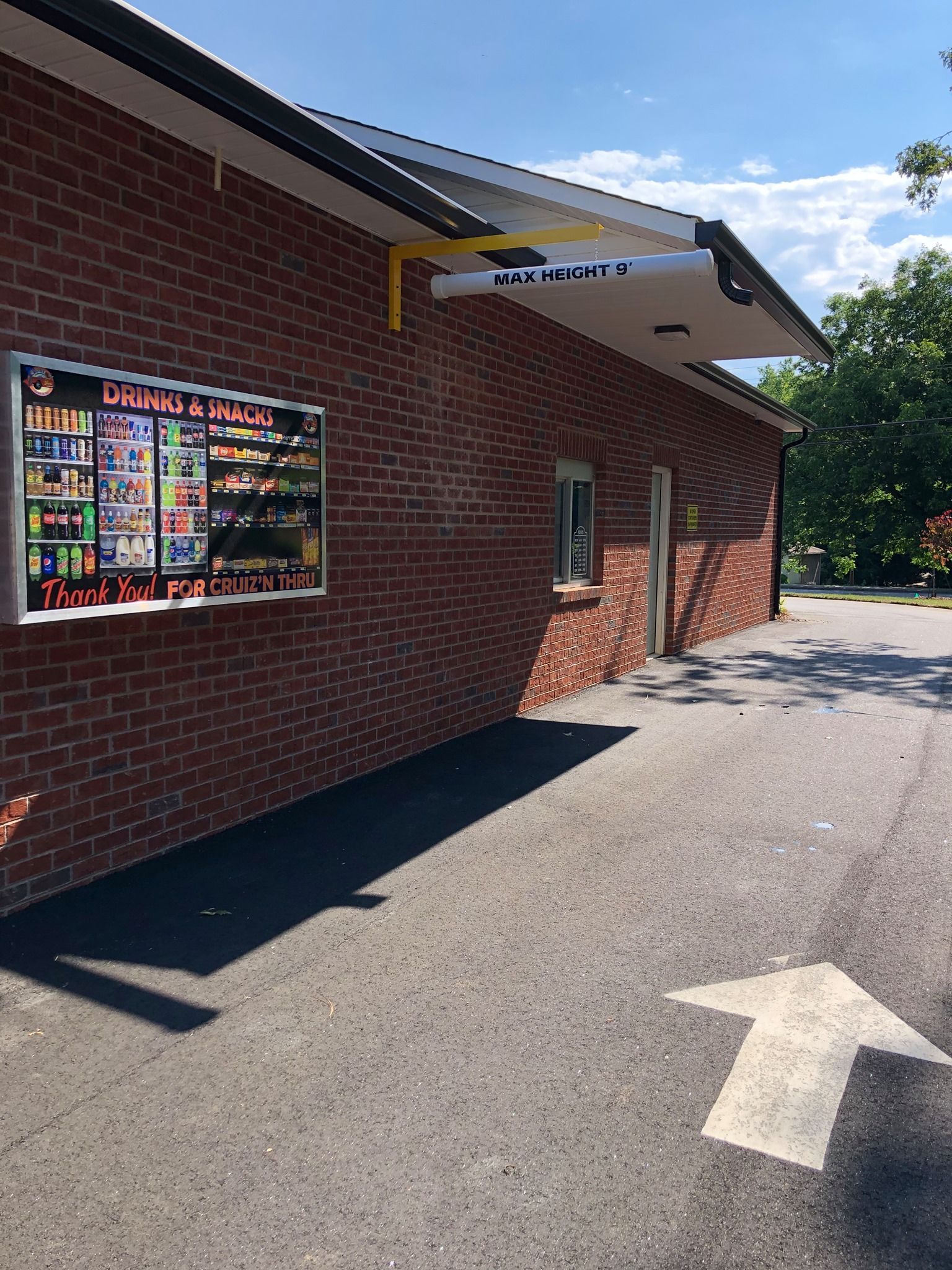 A pair of keys sitting next to a sign that says refinance your mortgage.