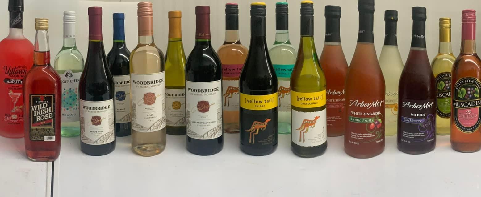 A large brick house is sitting in the middle of a lush green field.