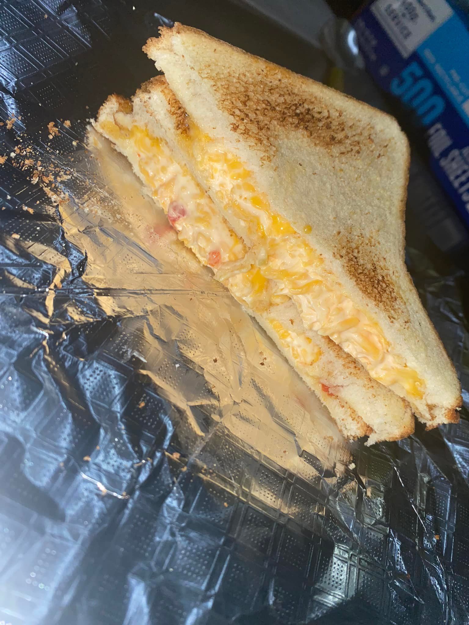 A model house is sitting on top of a pile of money.