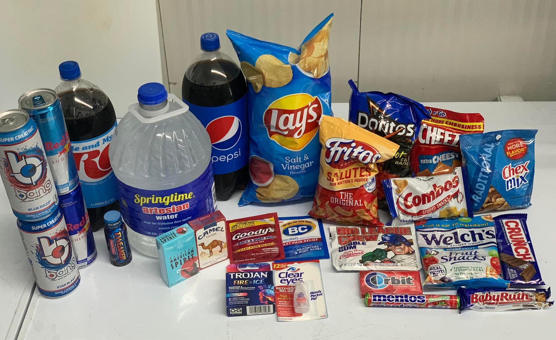 A house with a porch and a car parked in front of it.