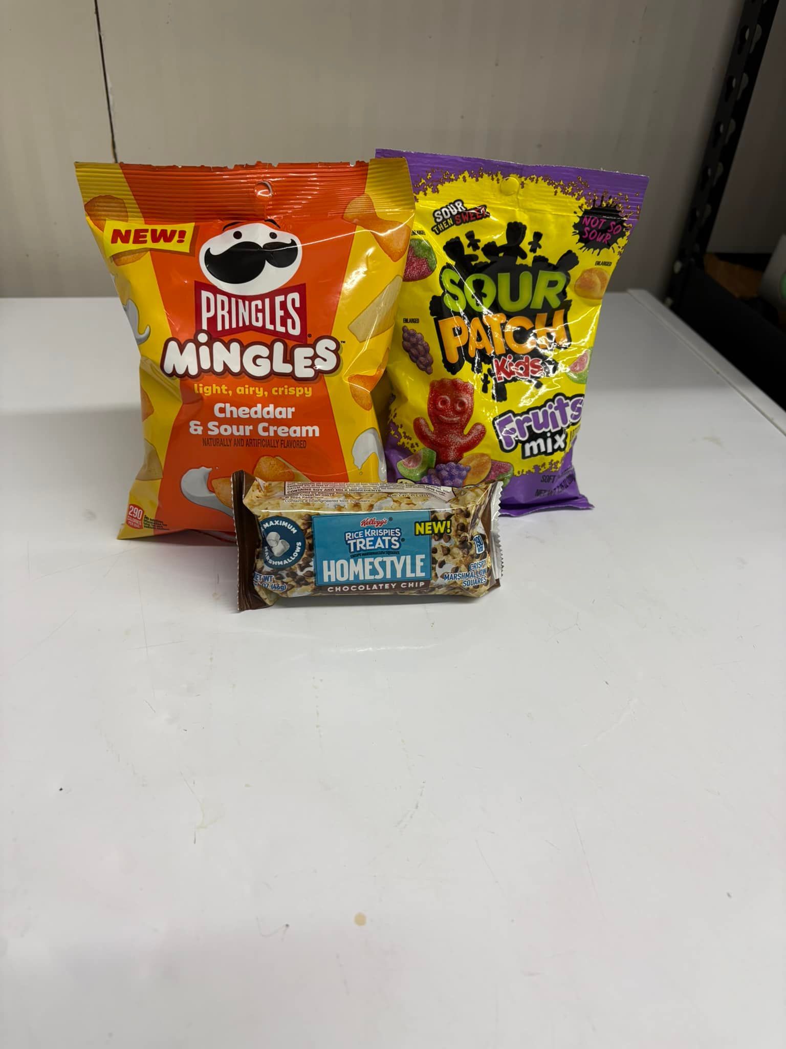 A large brick house is sitting in the middle of a lush green field.