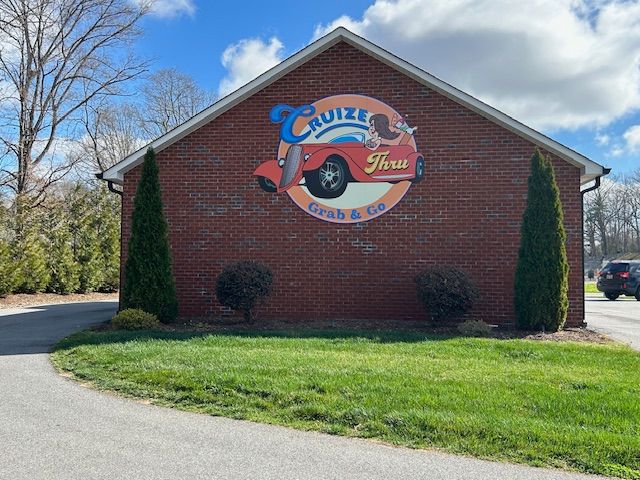 A brick building features a circular sign for 