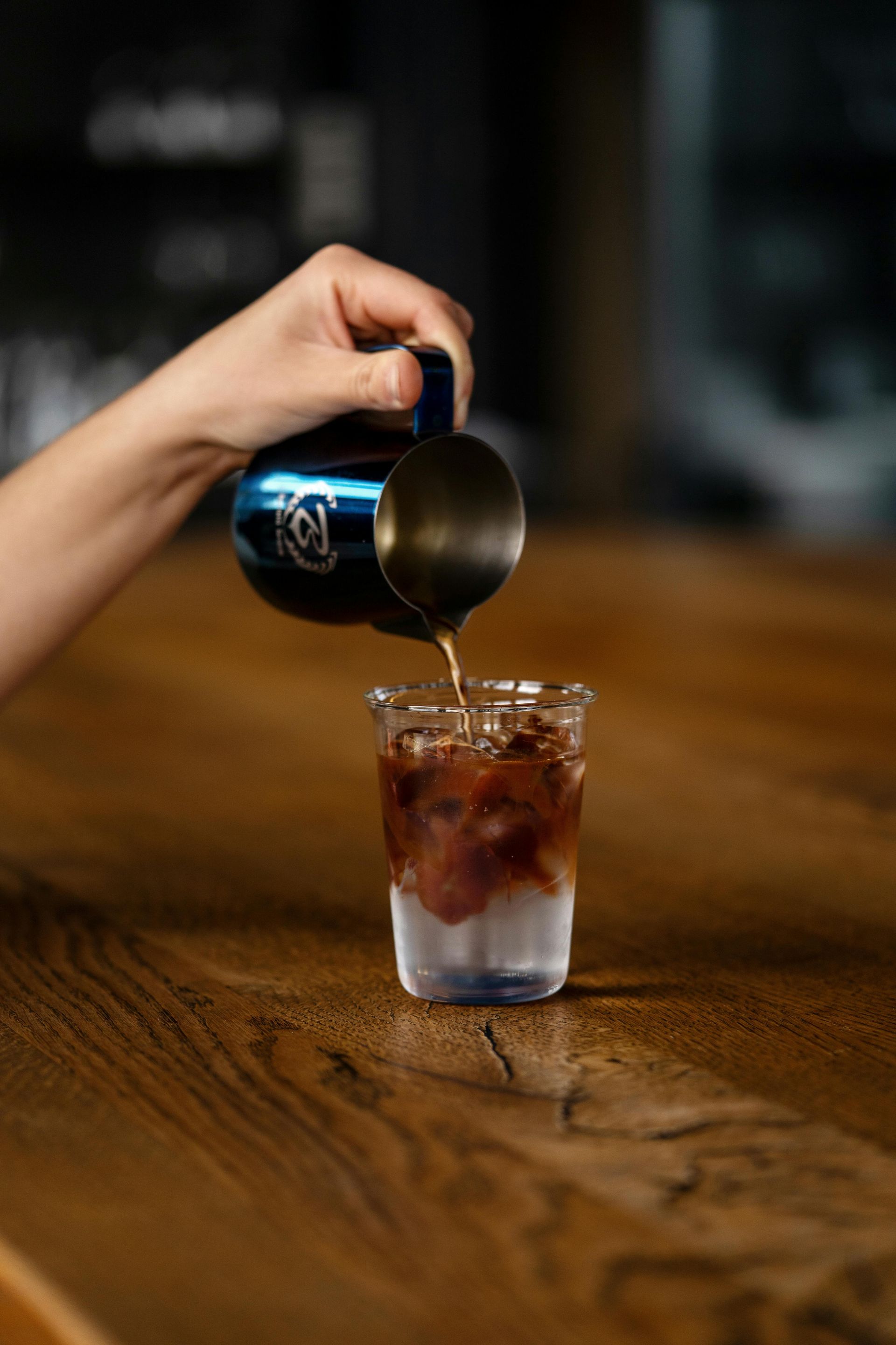 A lush green field with trees in the background on a cloudy day.