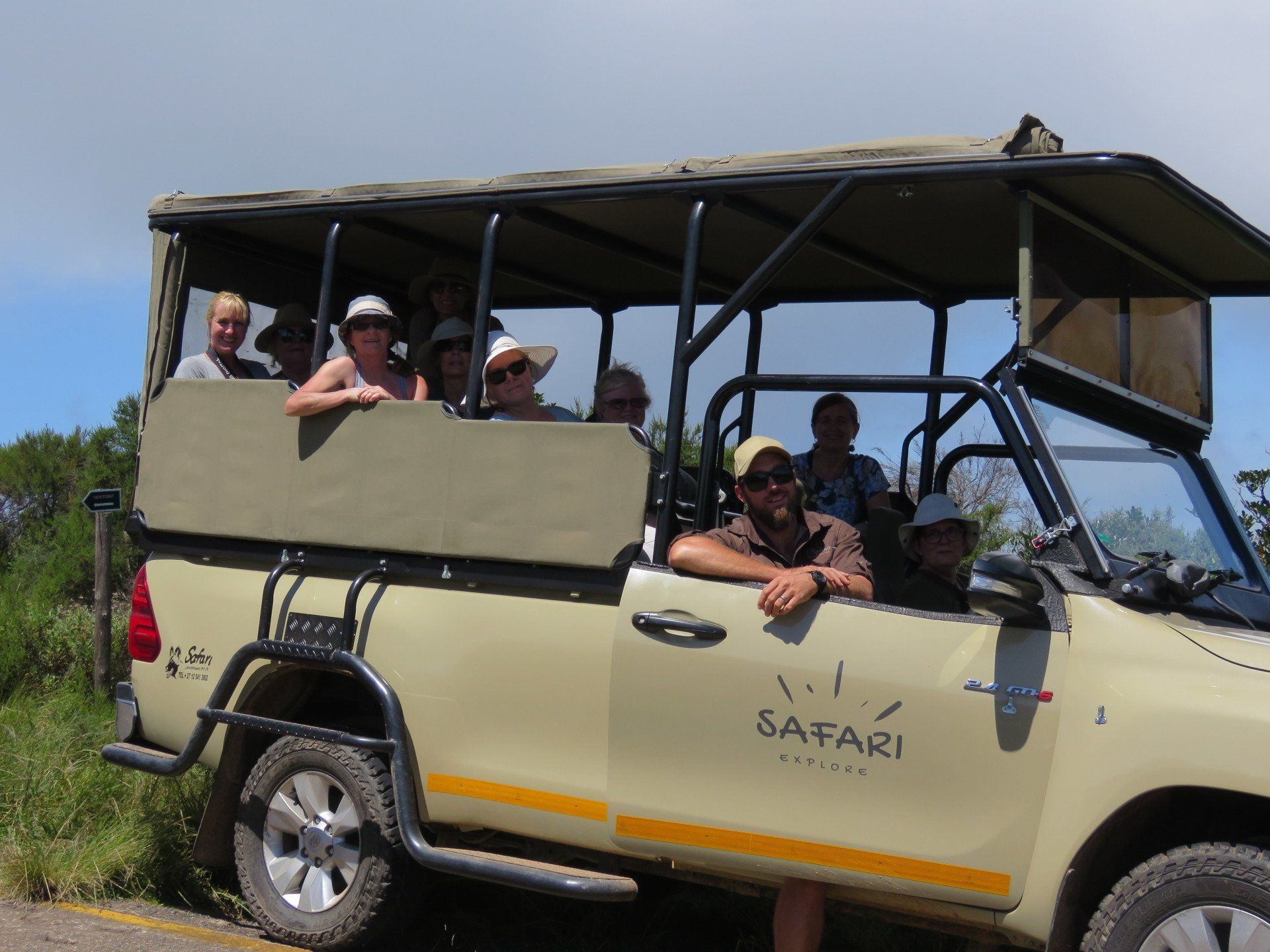 a group of people are in a safari vehicle