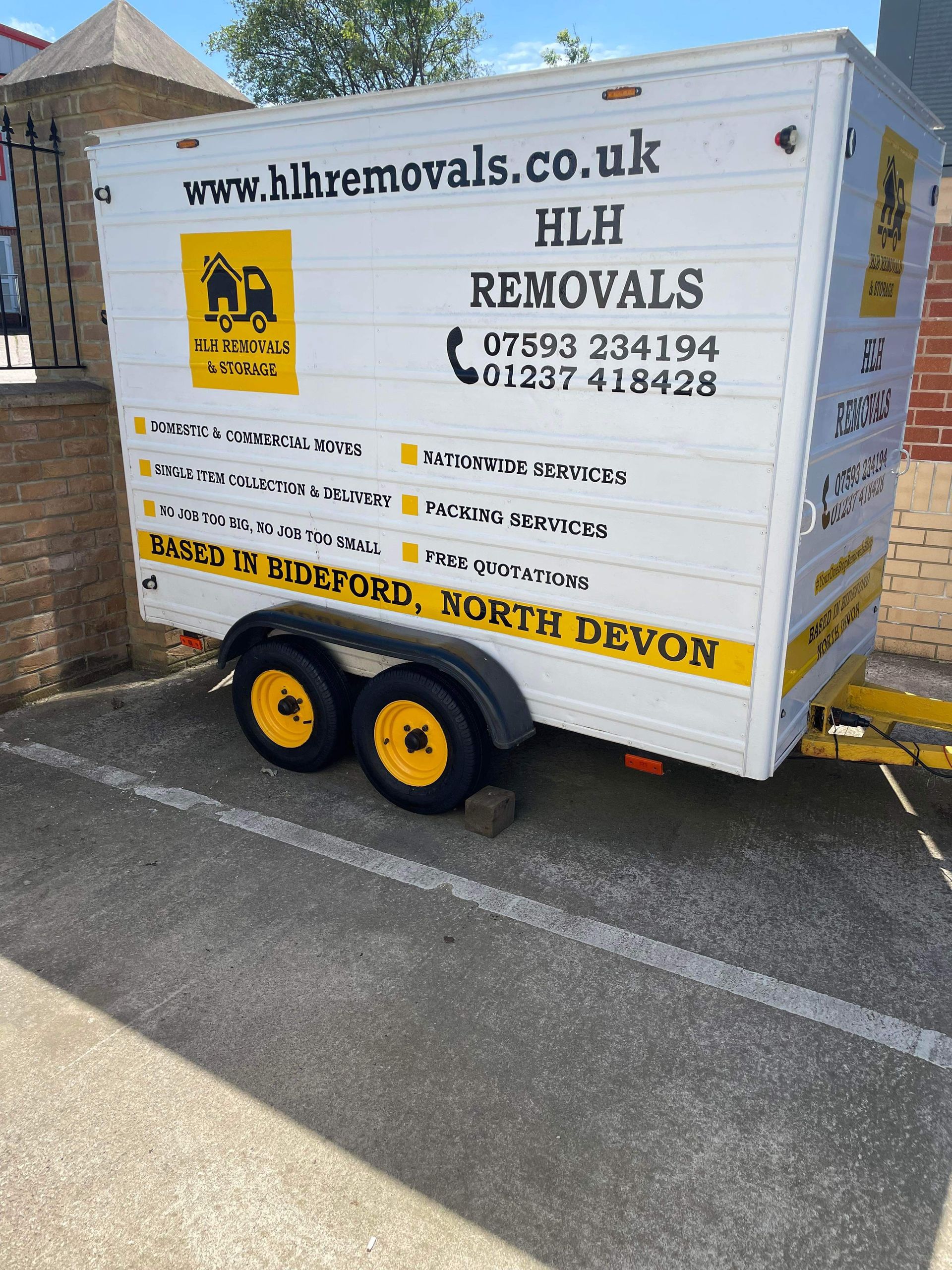 White HLH removals trailer parked outside. Text: www.hlhremovals.co.uk, phone number, services listed. Located in Underford, North Devon.