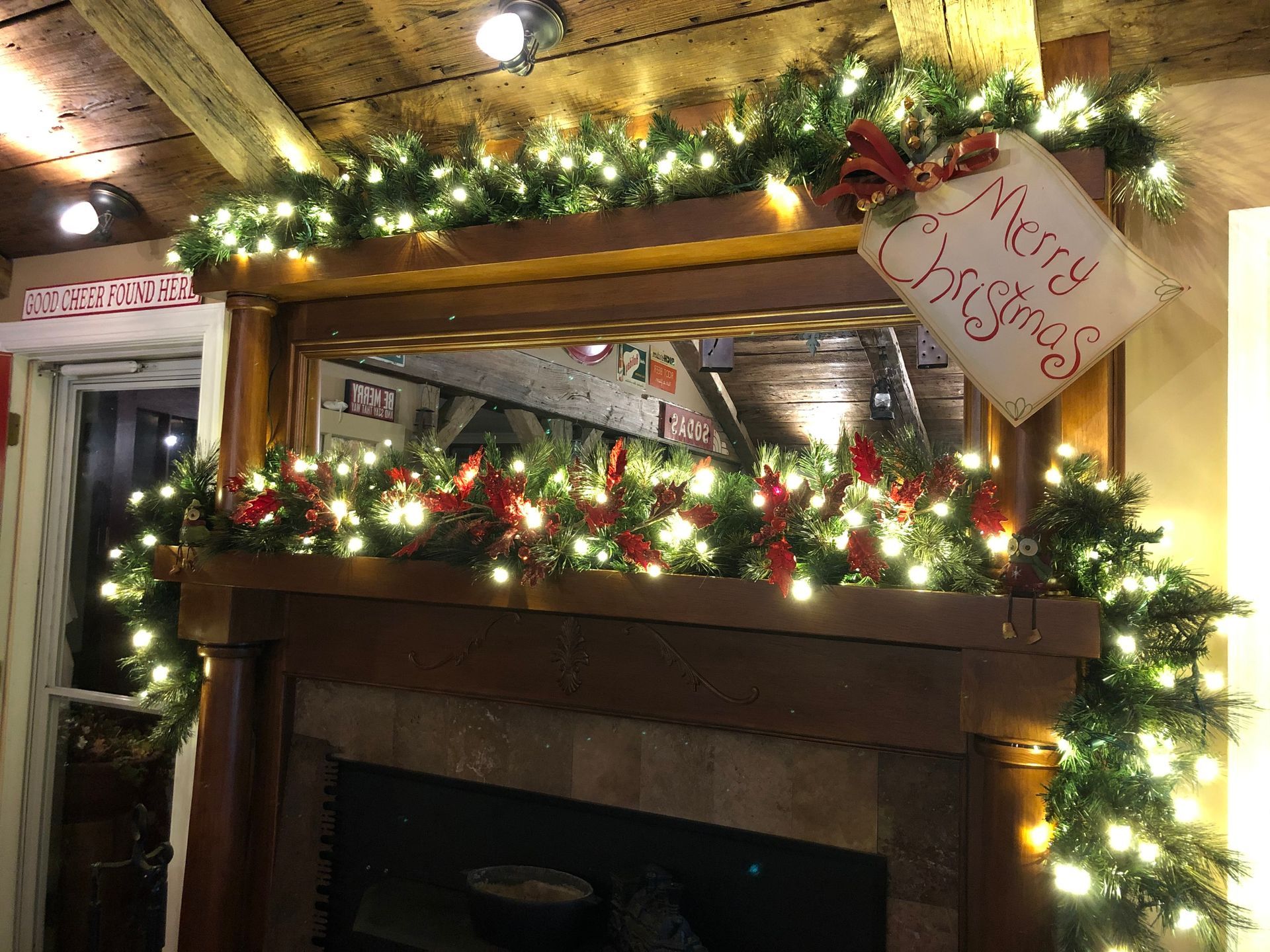 Fireplace decorated with Christmas garland and lights, 