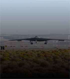 A fighter jet is taking off from a desert runway
