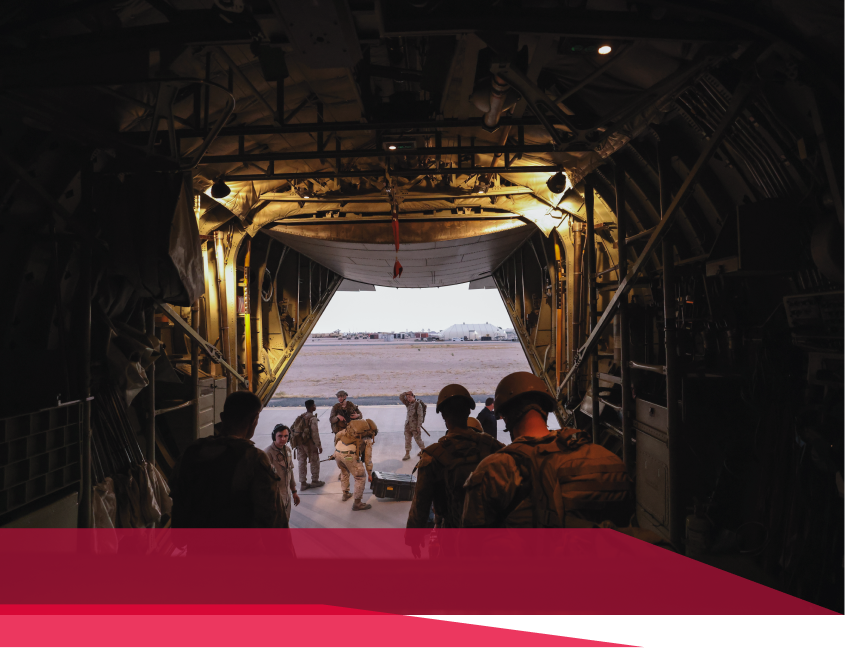 A group of soldiers are walking out of a plane