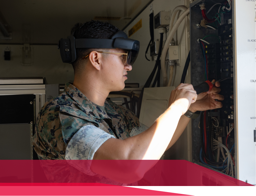 A man in a military uniform is working on a computer