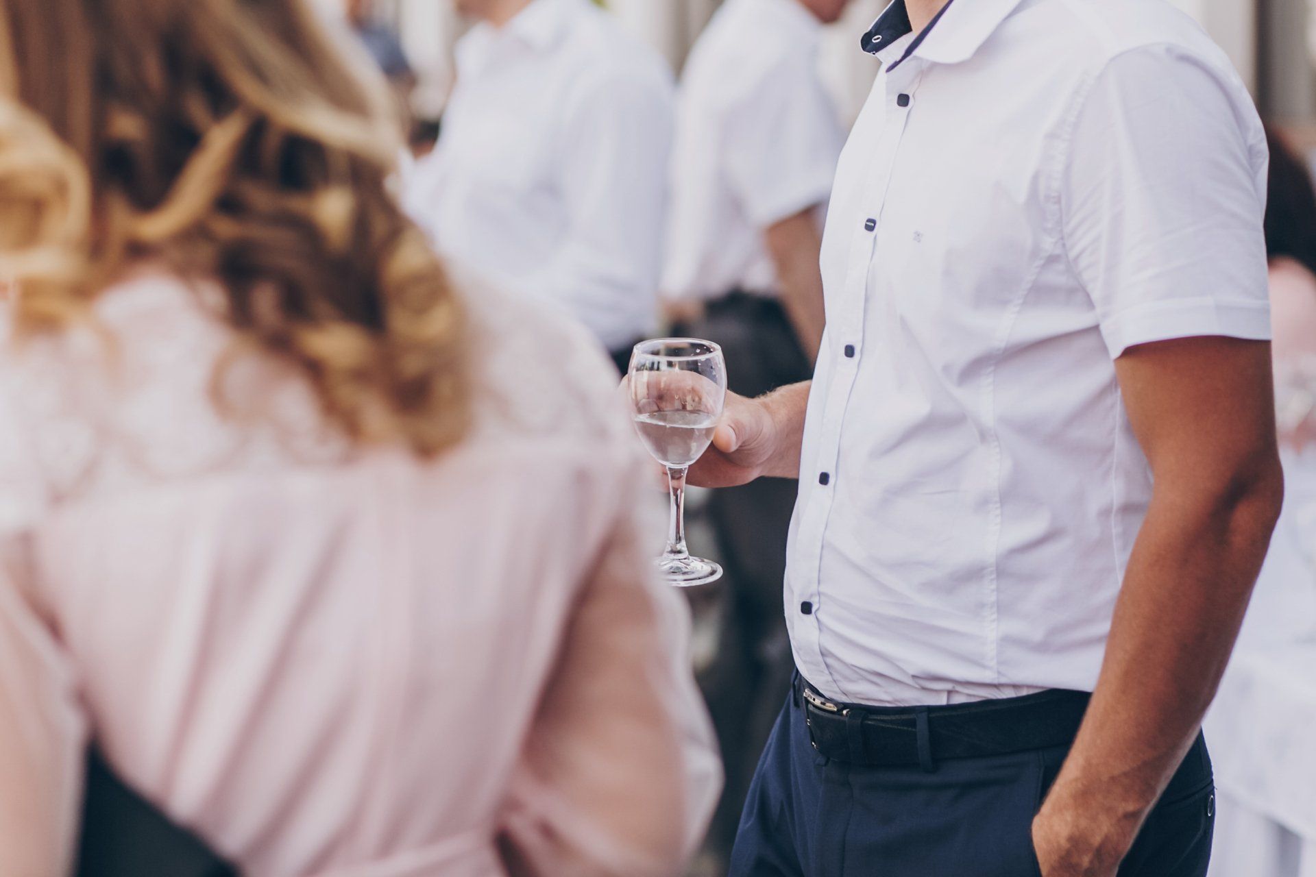 man holding champagne at a company event
