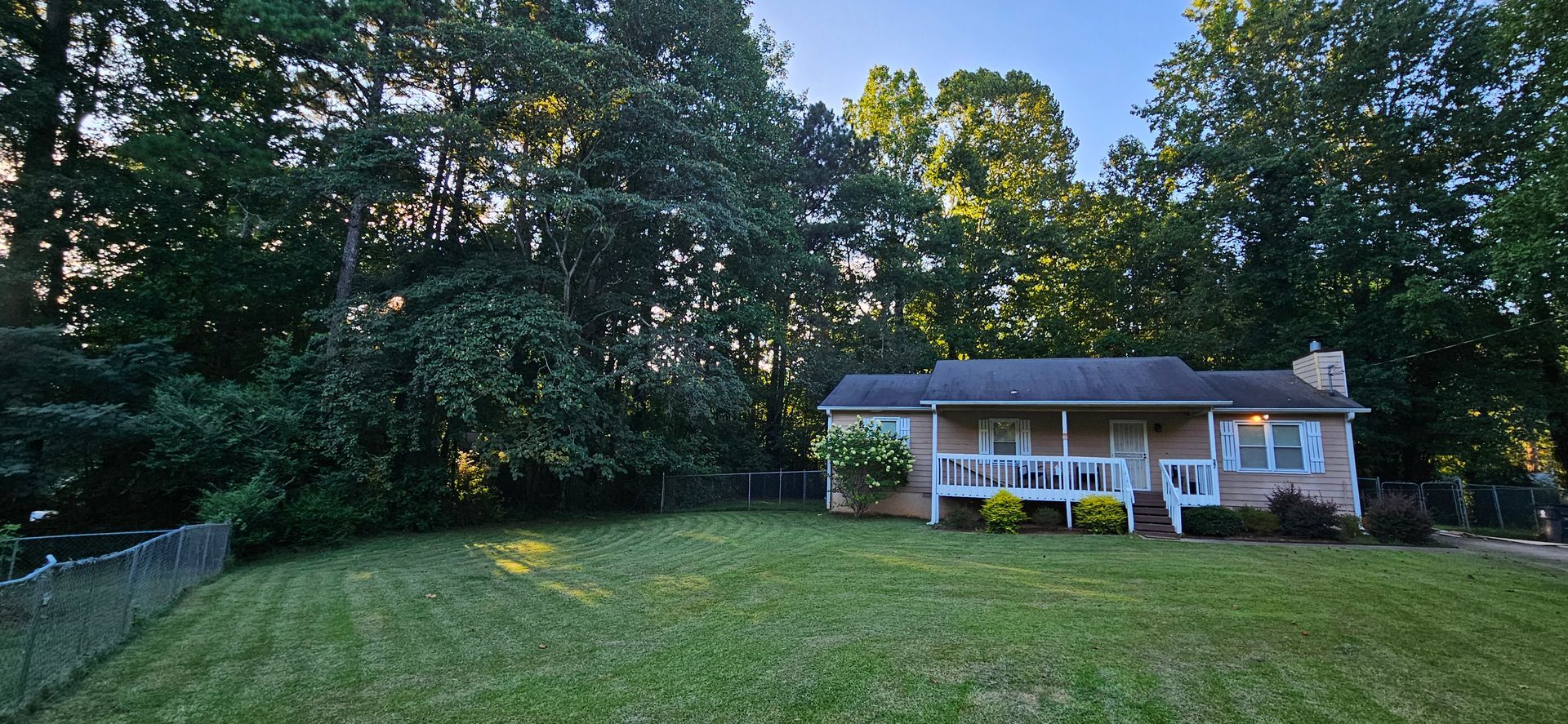 A house with a large lawn in front of it