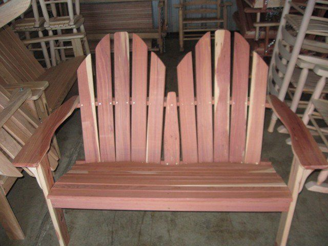 A wooden chair is sitting in a room with other chairs
