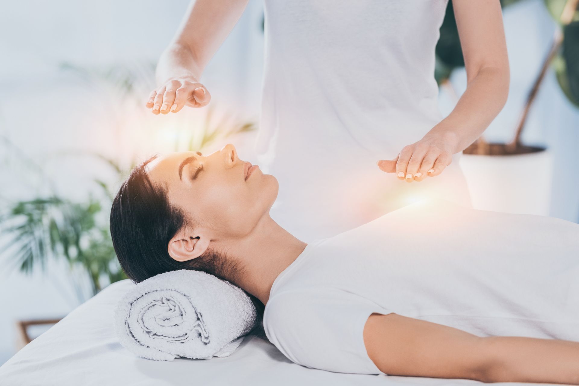 A woman is getting a healing session at a spa.