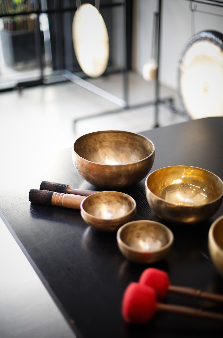 A table with brass bowls and red sticks on it