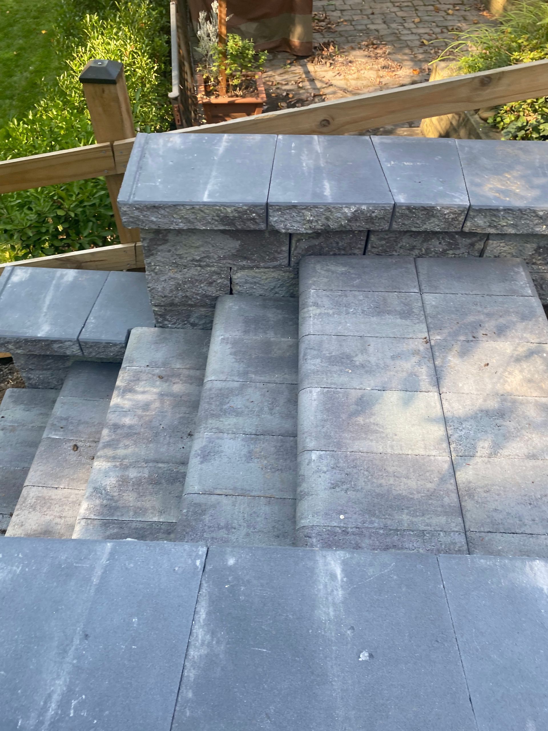 A set of stairs leading up to a wooden fence.