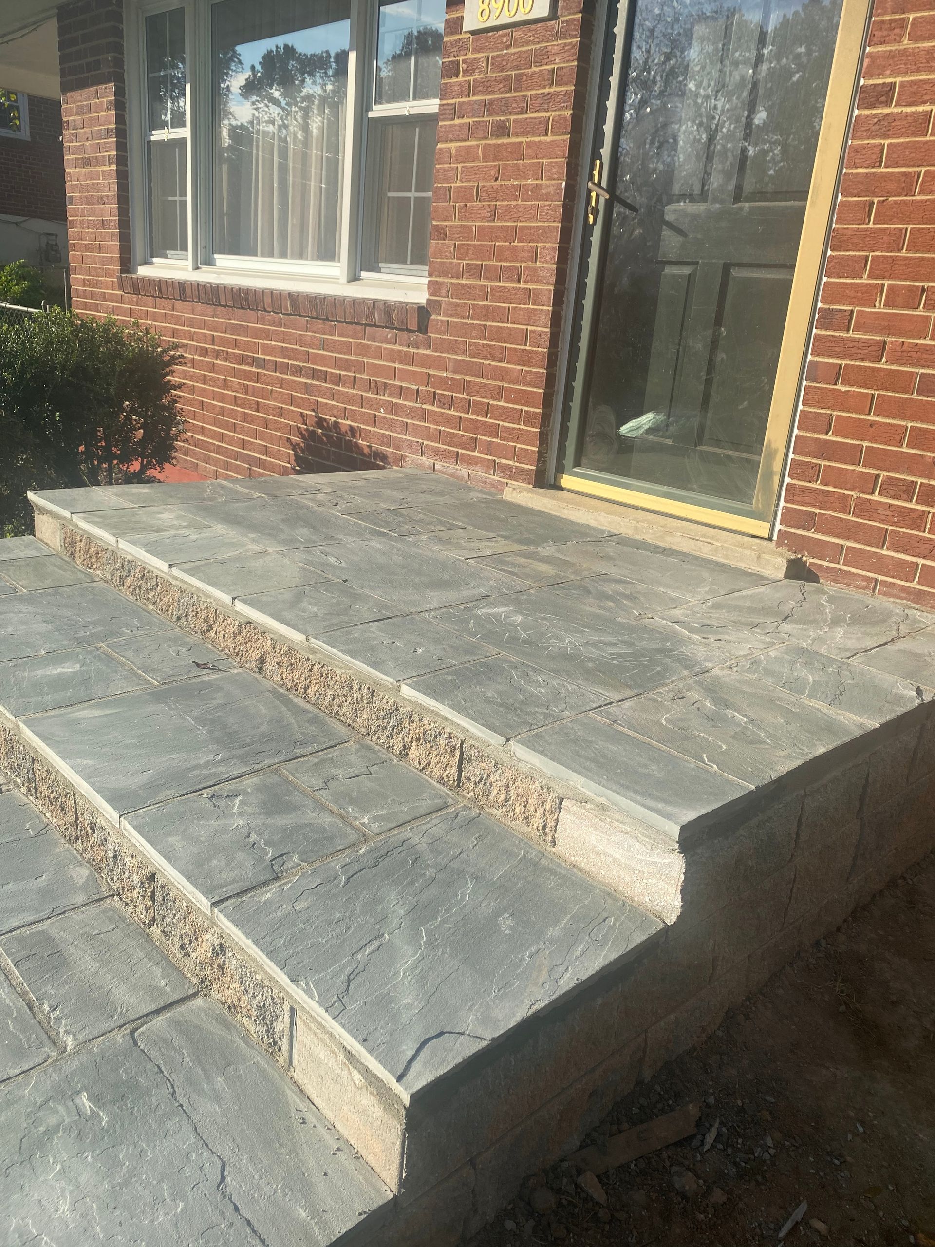 A set of stairs leading up to a brick house.