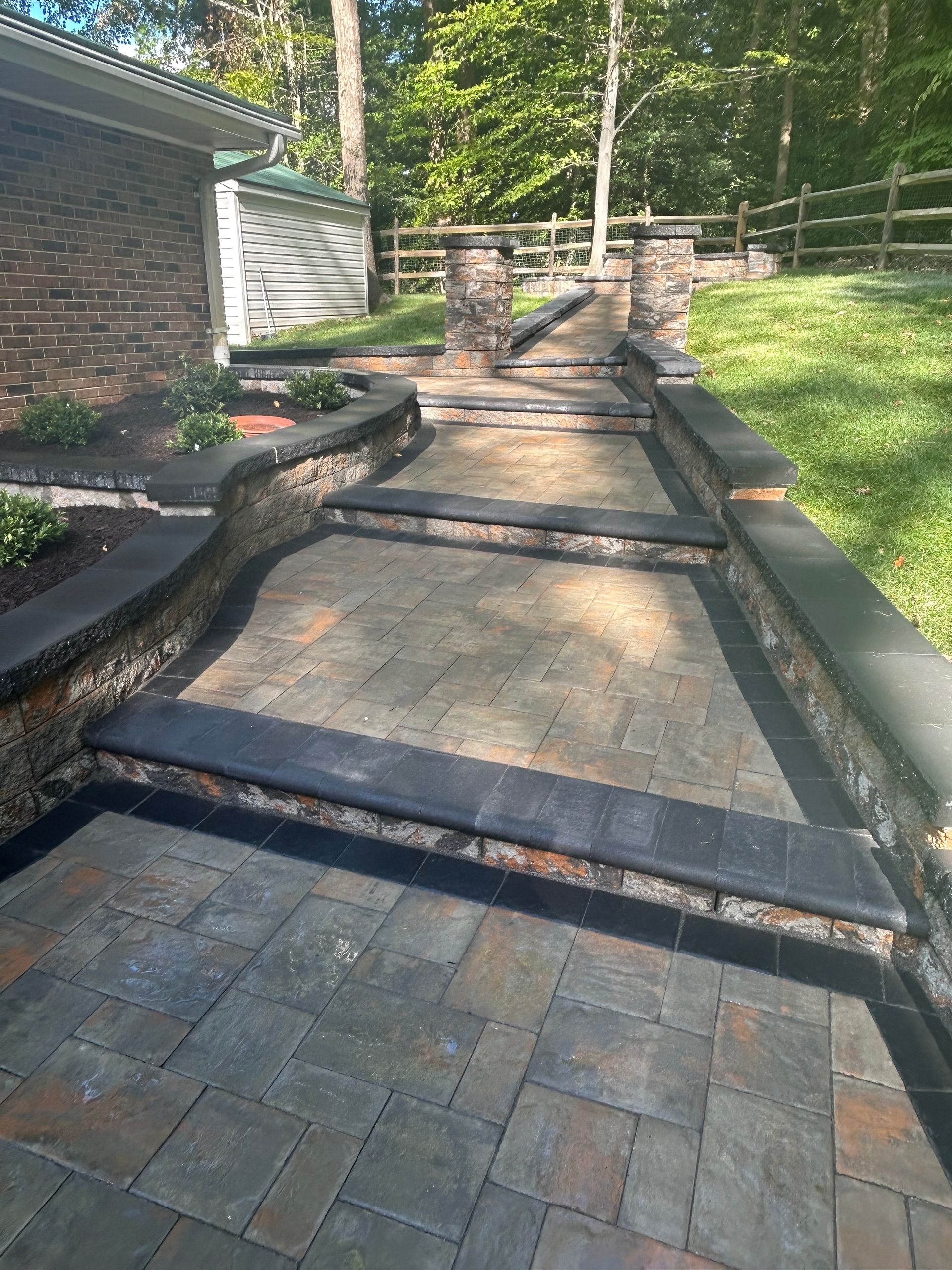 A brick walkway with stairs leading up to a house.