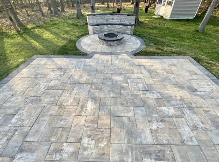 There is a fire pit in the middle of the patio.