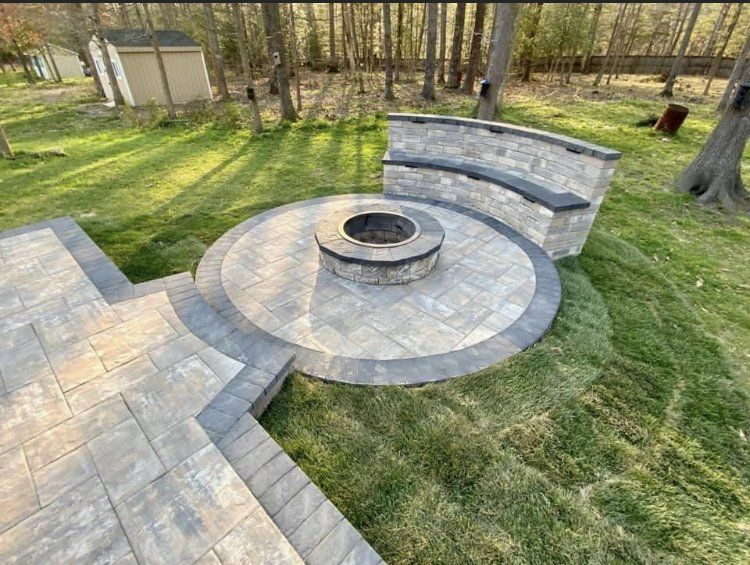 There is a fire pit in the middle of the patio.