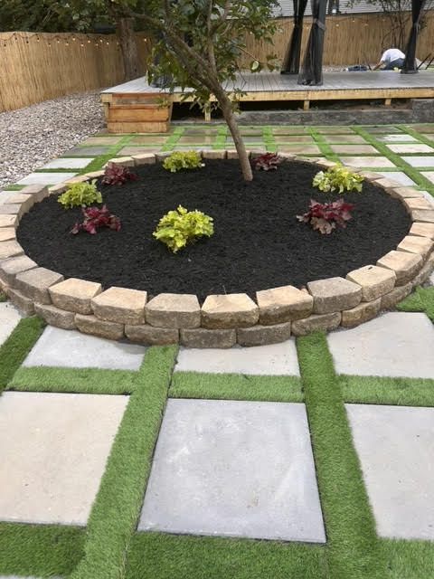 A garden with a tree in the middle of it