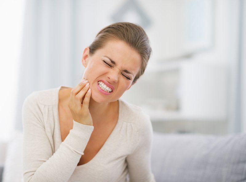 A woman having tooth pain - emergency dentist tuscaloosa al