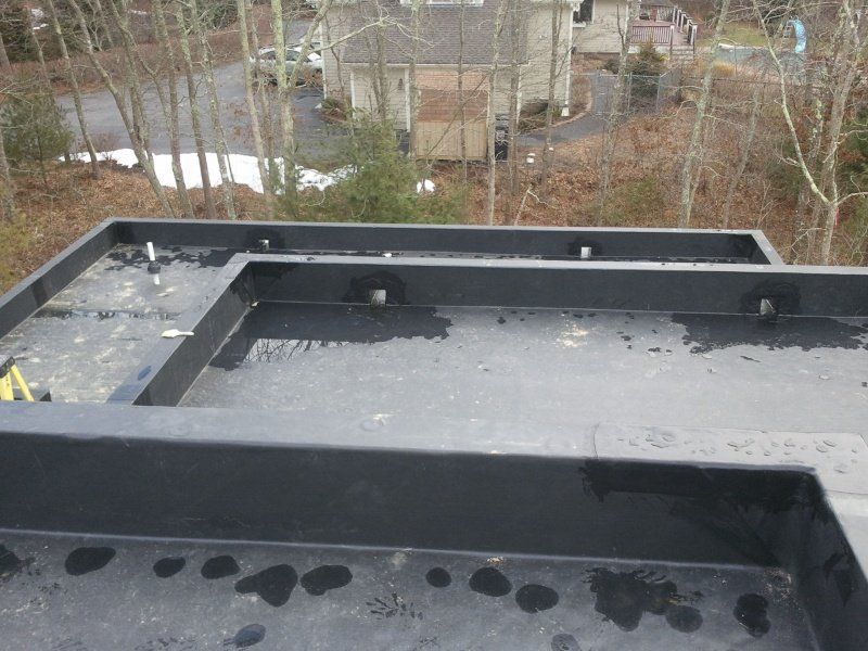 Water on Flat Roof — Cape Cod, MA — BelPort Building & Remodeling, LLC