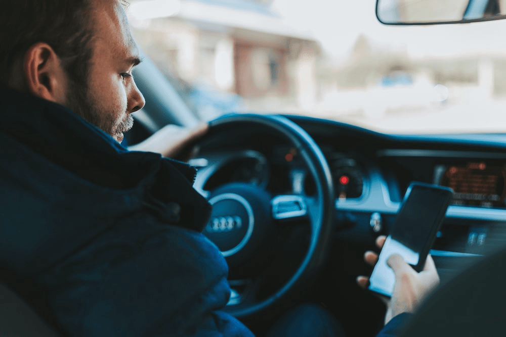 a man texting while driving