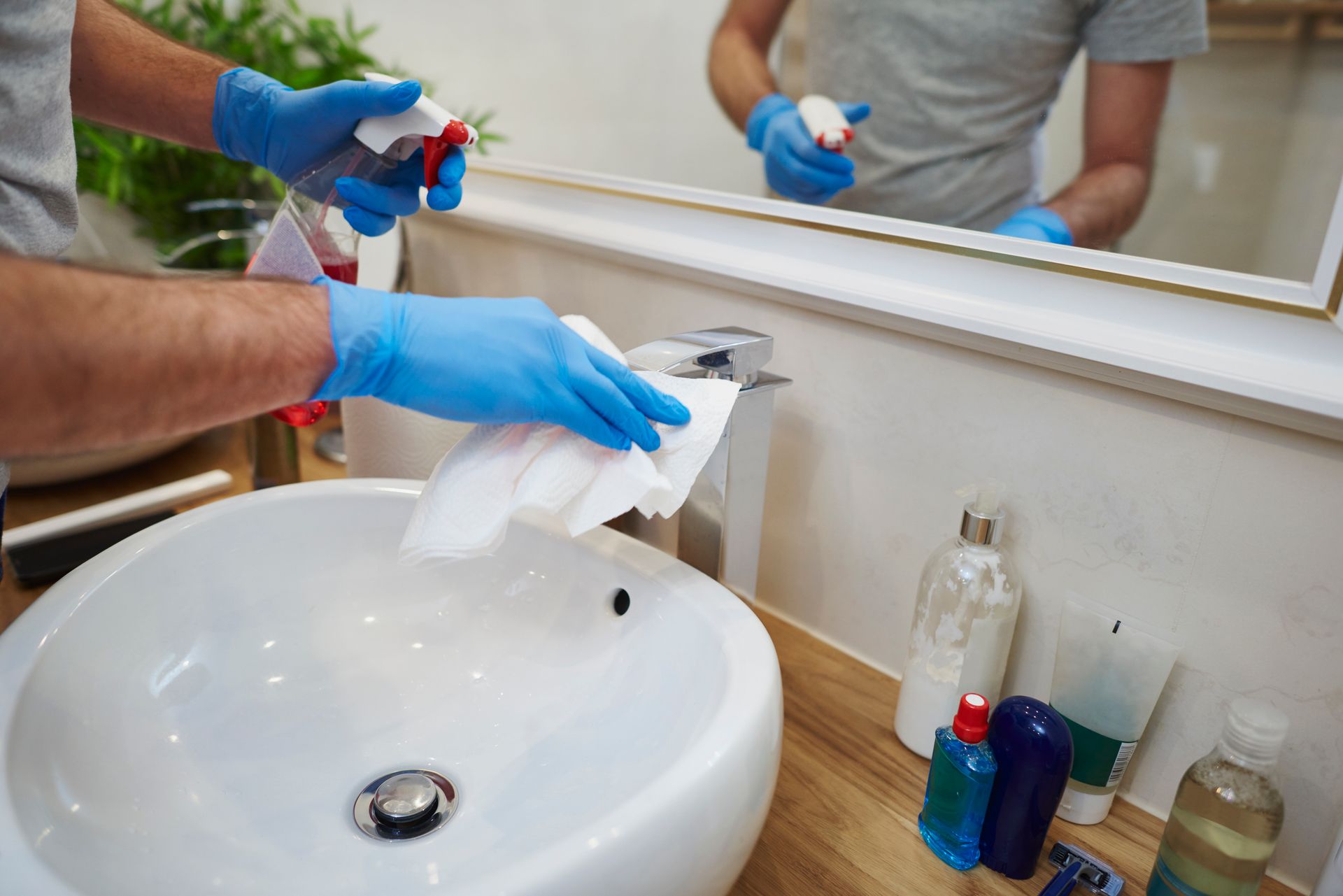 man cleaning bathroom sink