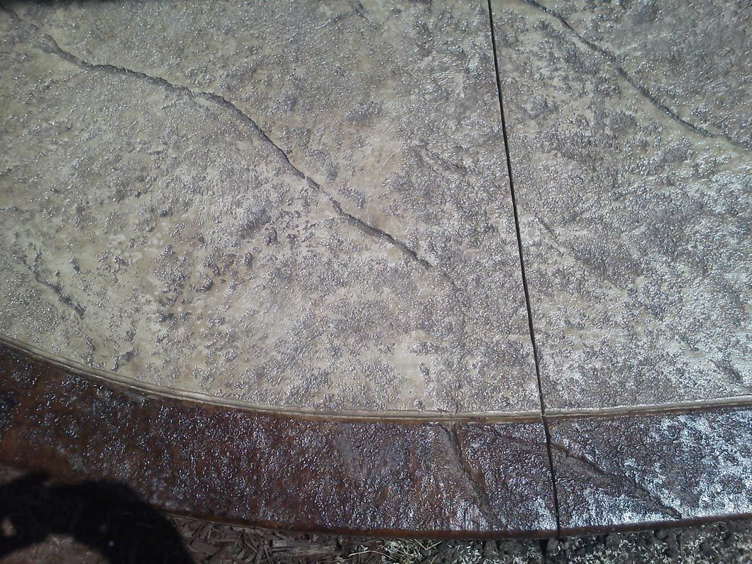 A close up of a concrete floor with a shadow on it.