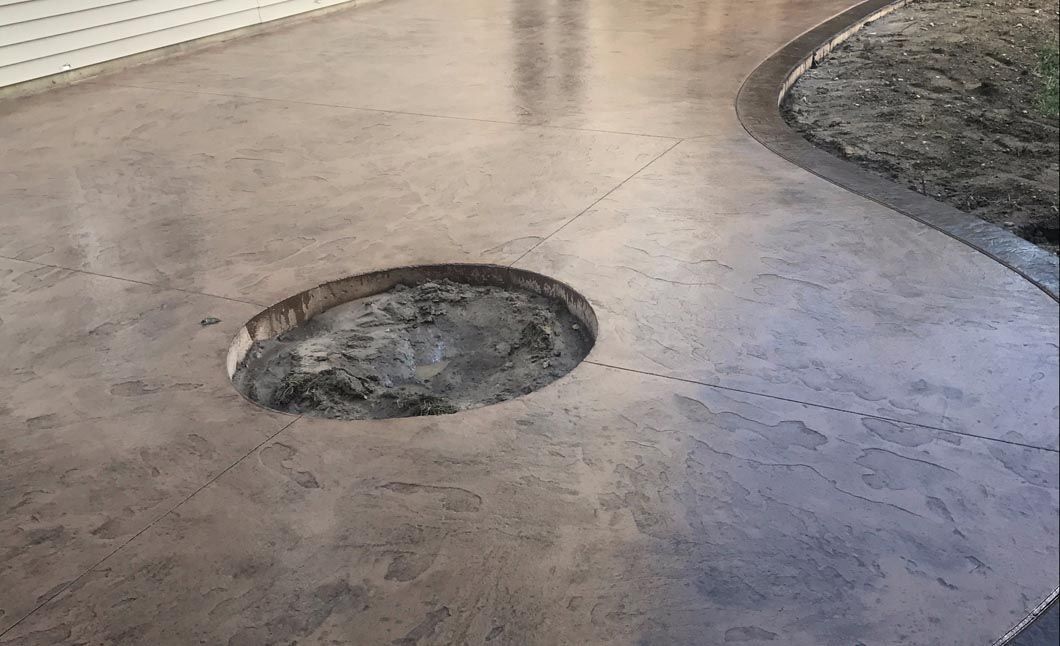 A concrete floor with a hole in the middle of it.