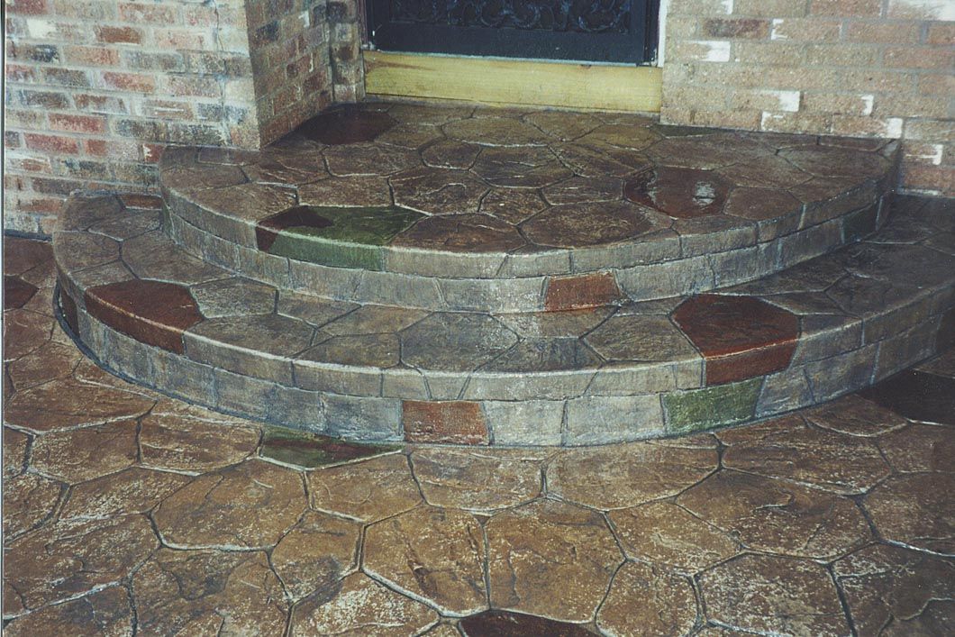 A stone staircase with a brick wall in the background