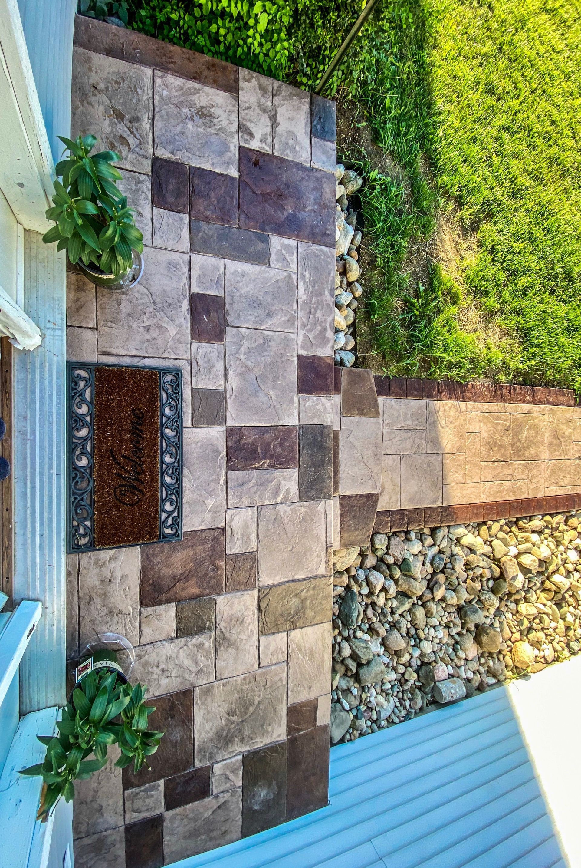 An aerial view of a stone walkway leading to a house.
