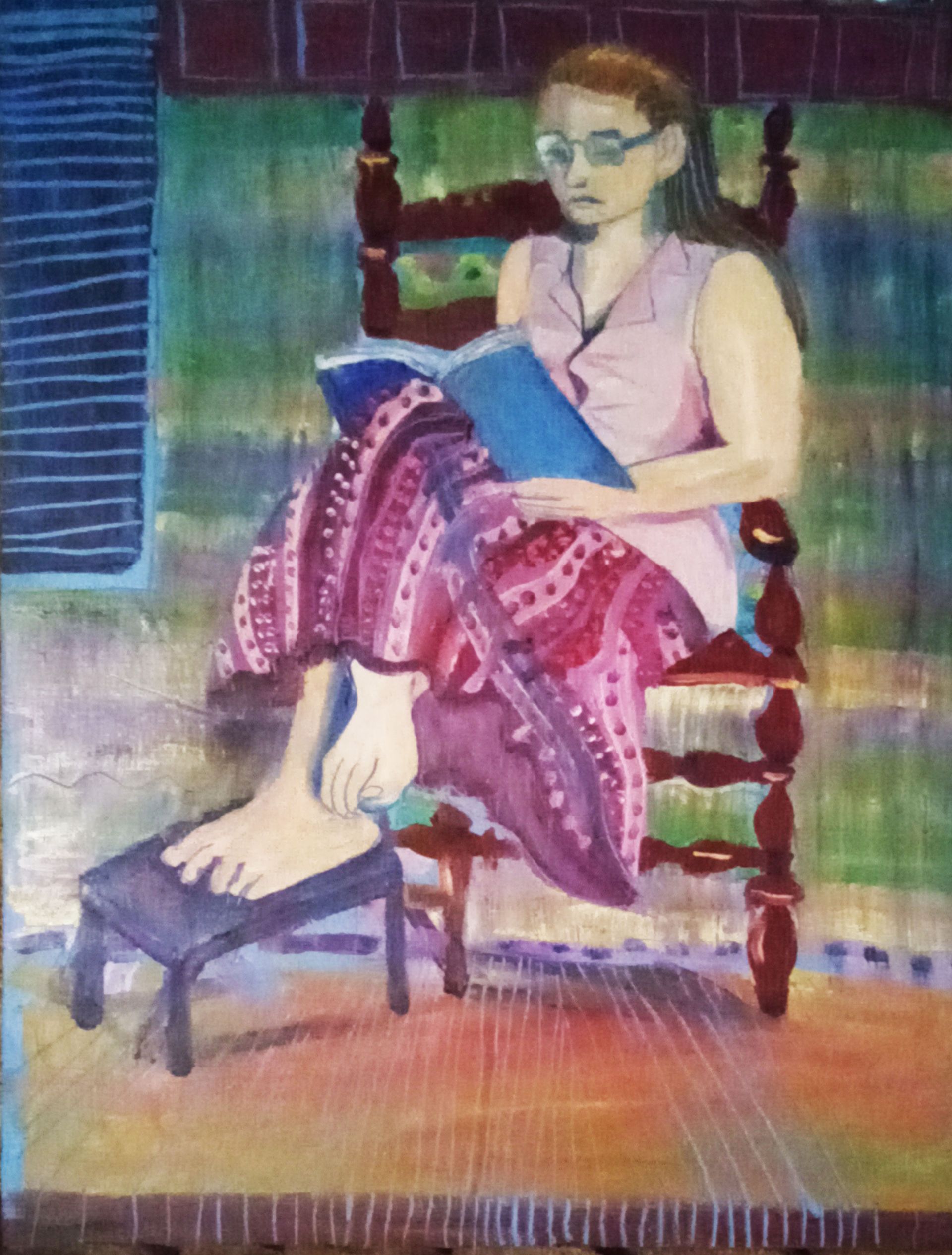 Woman reading in a chair with foot on a stool. Pink dress, red skirt, glasses, brick wall, rainbow.