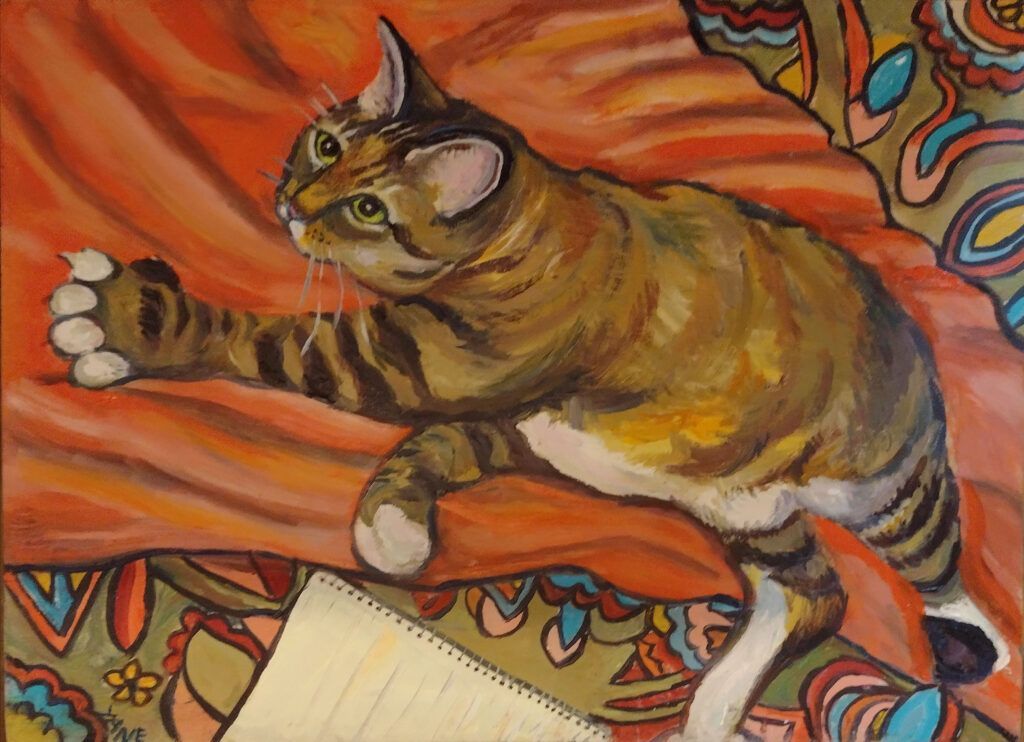 Tabby cat, stretched out, playing on an orange blanket with a patterned border.