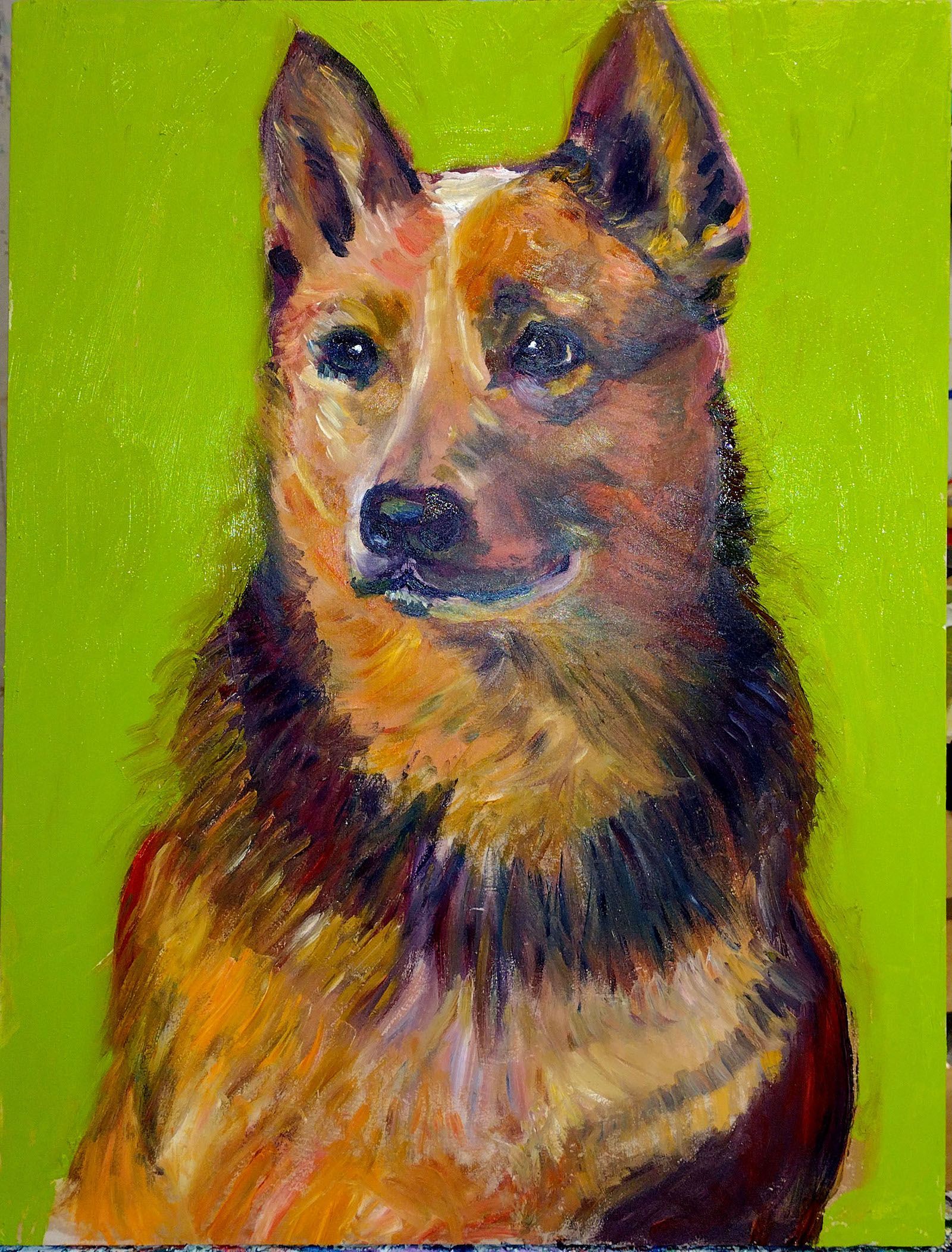 Dog portrait, red and black fur, green background.